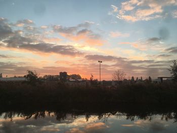 Scenic view of lake against orange sky