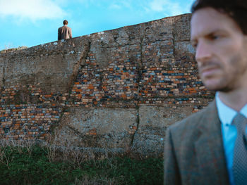 Man standing against wall