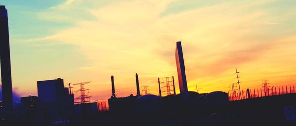 Low angle view of silhouette buildings against sky during sunset