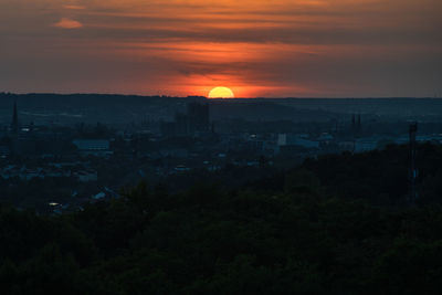 High angle view of townscape against orange sky