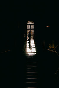 Man walking by window in building