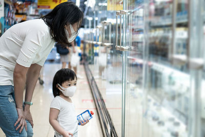 Mother and daughter shopping in store