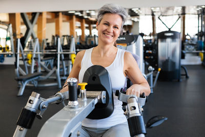 Portrait of woman exercising in gym