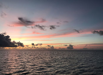 Scenic view of sea against romantic sky at sunset