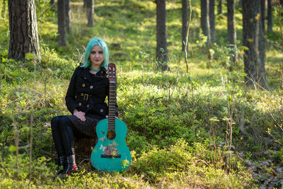 Portrait of smiling young woman in forest