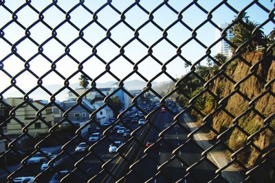Chainlink fence at sunset seen through train window