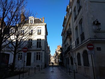 Street amidst buildings against sky