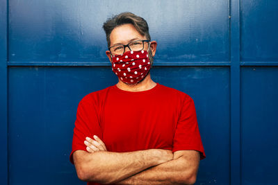 Portrait of man standing against wall