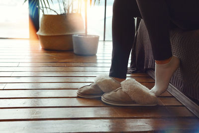 Low section of woman on hardwood floor