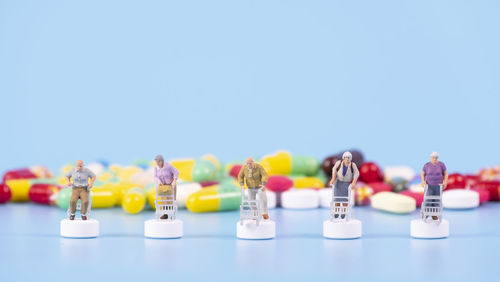 Close-up of toys on table against blue sky