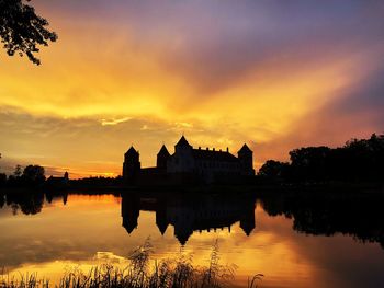 Scenic view of lake against romantic sky at sunset