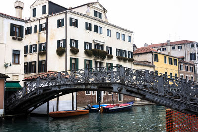 Bridge over canal amidst buildings in city