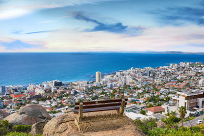 High angle view of townscape by sea against sky