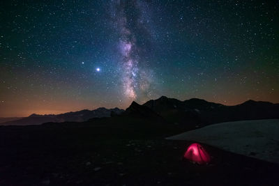 Scenic view of mountains against sky at night