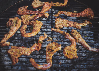 High angle view of meat on barbecue grill