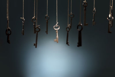 Close-up of keys hanging against wall