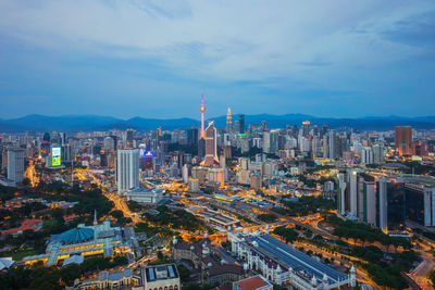 Illuminated cityscape against sky