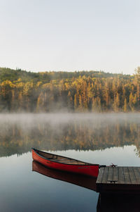 Morning view on lake with canoe and fog