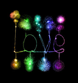 Illuminated firework display over black background