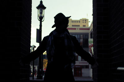 Silhouette man standing in city