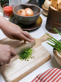 Close-up of man preparing food on cutting board