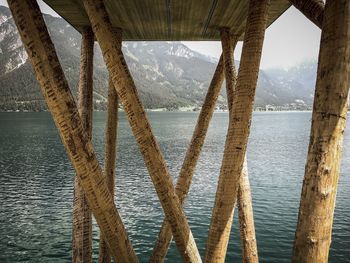 Reflection of bridge in sea against sky