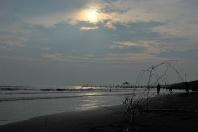 Scenic view of beach against sky during sunset