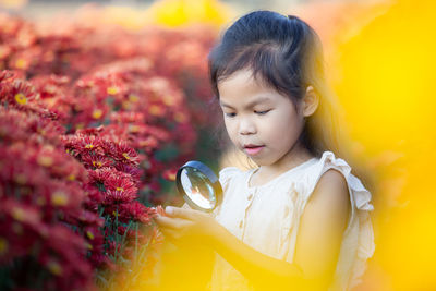 Close-up of girl with yellow flowers