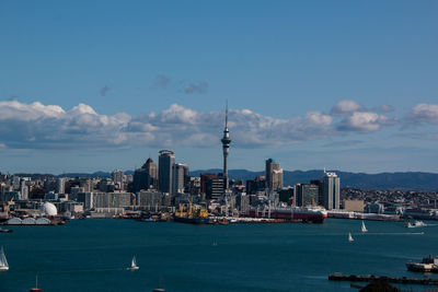 View of cityscape and sea against sky