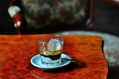 Close-up of espresso with ice in glass on table