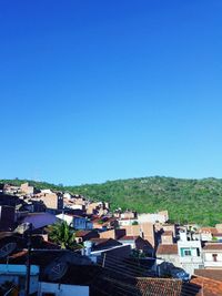 High angle view of townscape against clear blue sky