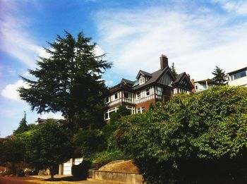 Low angle view of building against cloudy sky