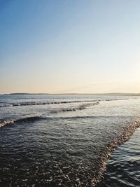 Scenic view of sea against clear sky during sunset