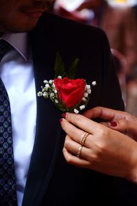 Midsection of bride holding bouquet