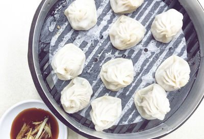 High angle view of dim sum in bento box on table