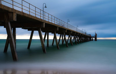 Pier over sea against sky