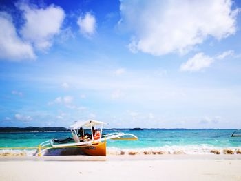 Boat on beach against sky