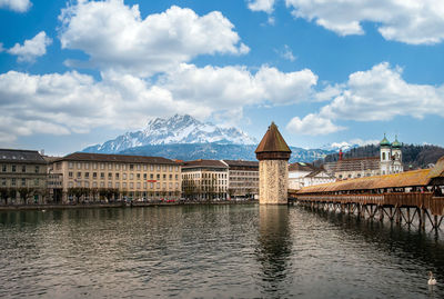 Bridge over river with buildings in background