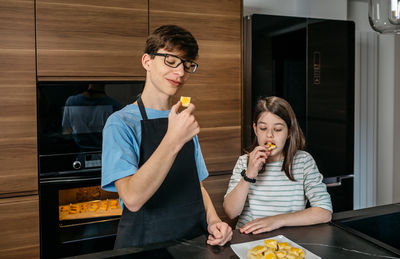 Portrait of young woman drinking coffee at home