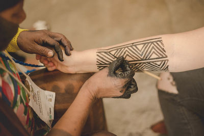 Midsection of couple holding hands