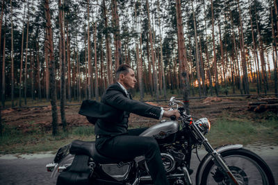 Man riding bicycle in forest