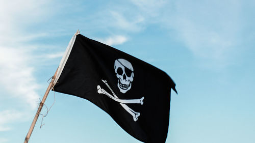 Low angle view of flag against sky