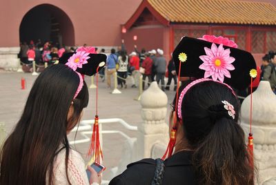 Rear view of women with headbands at forbidden city