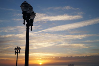 Low angle view of street light against sky during sunset