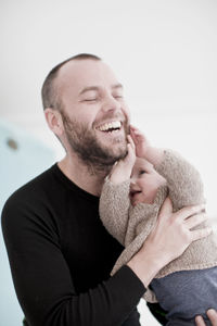 Happy mother and baby girl with hands