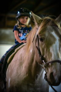 Portrait of teenage girl riding horse