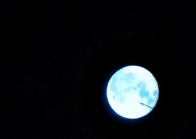 Low angle view of moon against dark sky