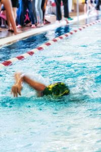 Man swimming in pool during competition