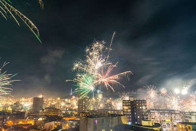 Low angle view of firework display at night