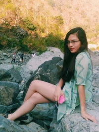 Woman sitting on rock